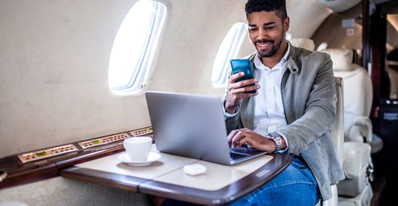 A male passenger is using Viasat JetXP in flight