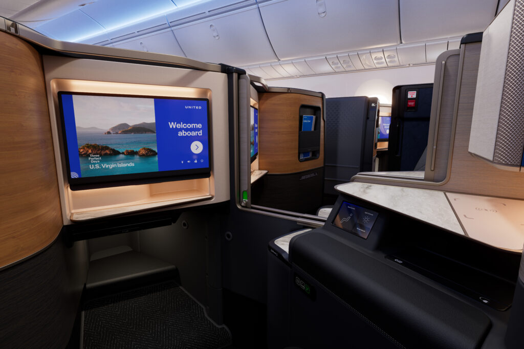 Looking inside the United Polaris doored suite with a focus on the large IFE screen.