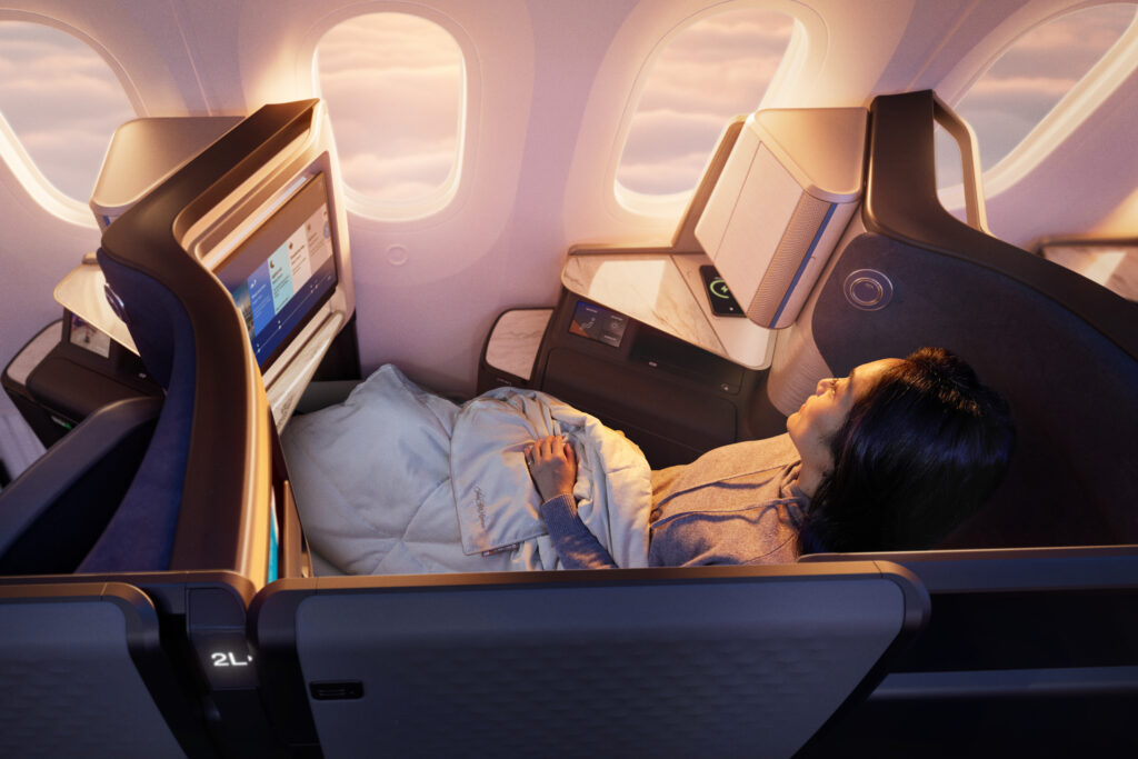 A woman is laying down sleeping in the Polaris doored suite.