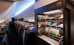 A self-serve bar in United Polaris business class features various drinks and snacks.