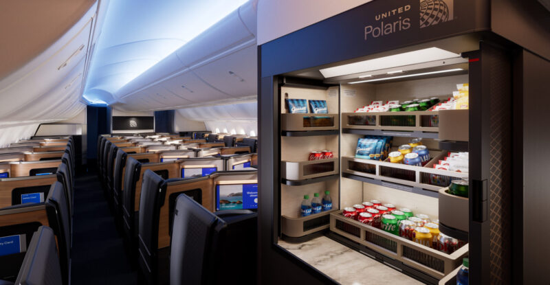 A self-serve bar in United Polaris business class features various drinks and snacks.