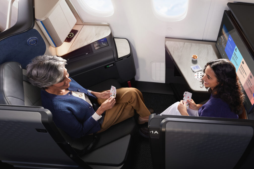 Two people are facing each other, playing cards in the United Polaris Studio