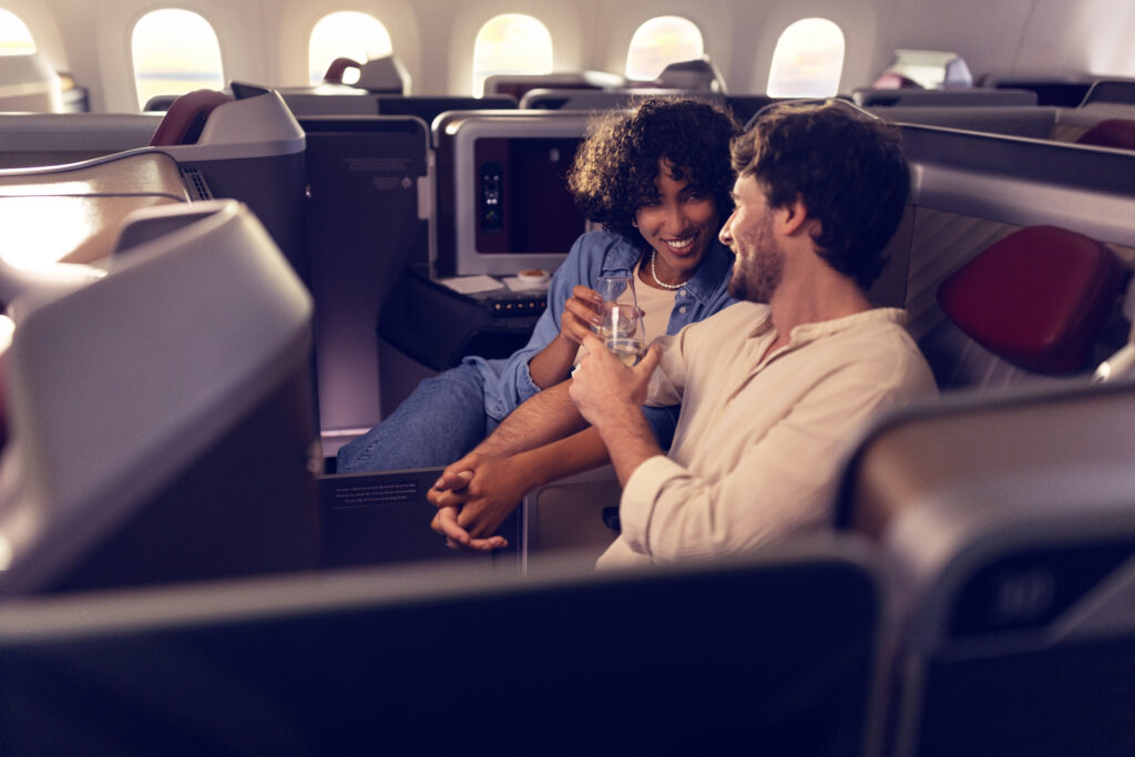 A man and woman are talking next to each other in their LATAM Premium Business Recaro R7 seats