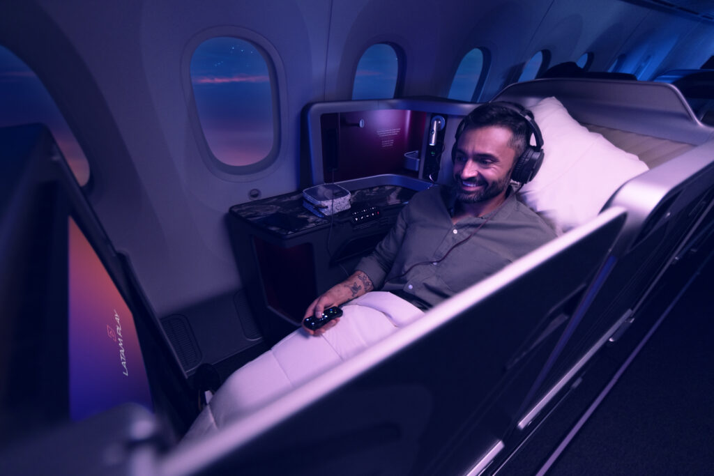 A man is relaxing in the LATAM Premium Business Recaro R7 seat