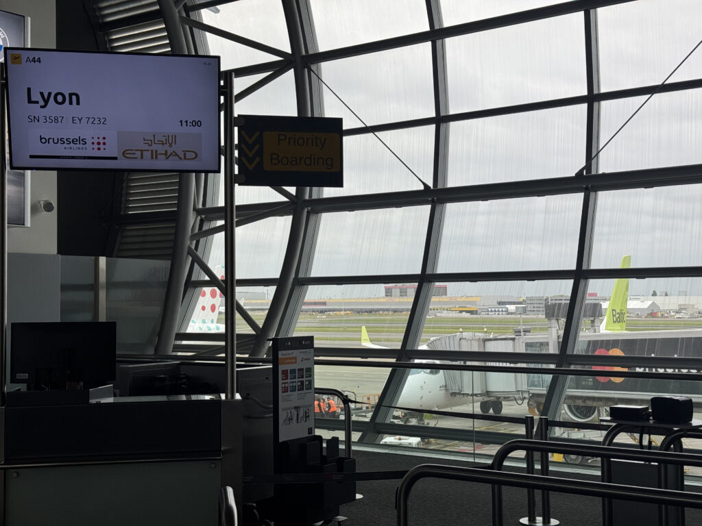 A gate at Brussels Airport, with a display showing the destination is Lyon.