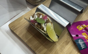 Plant-based pulled pork-style tacos on display for guests to try at AIX 2025