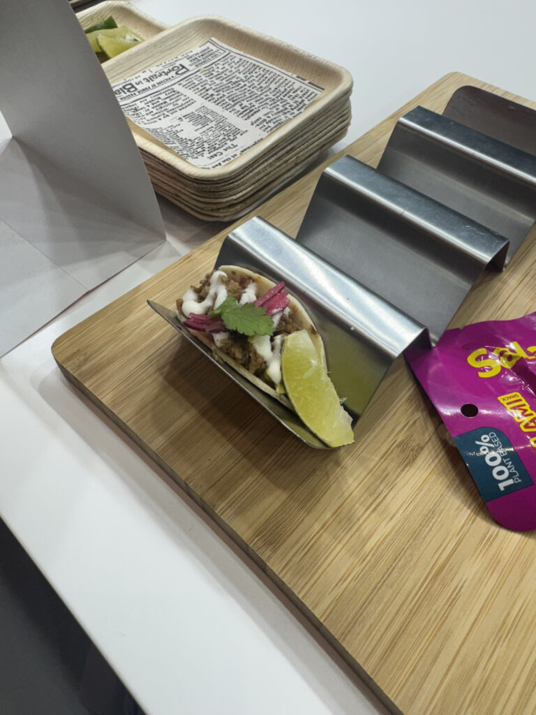 Plant-based pulled pork-style tacos on display for guests to try at AIX 2025