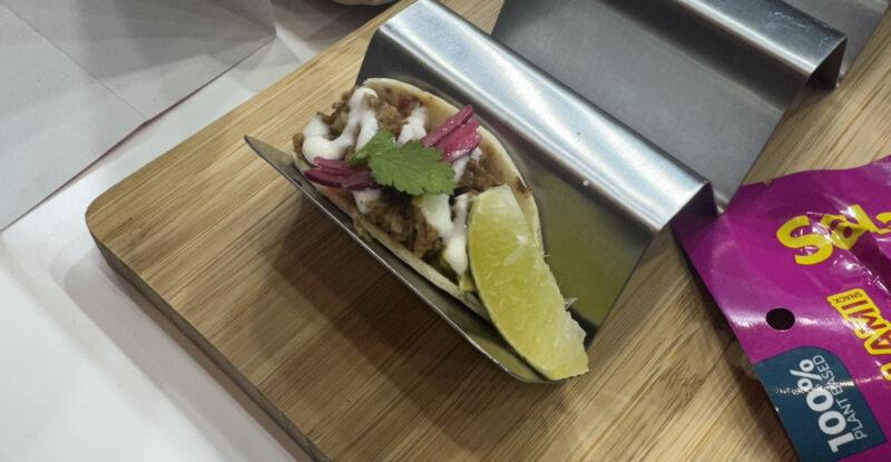 Plant-based pulled pork-style tacos on display for guests to try at AIX 2025
