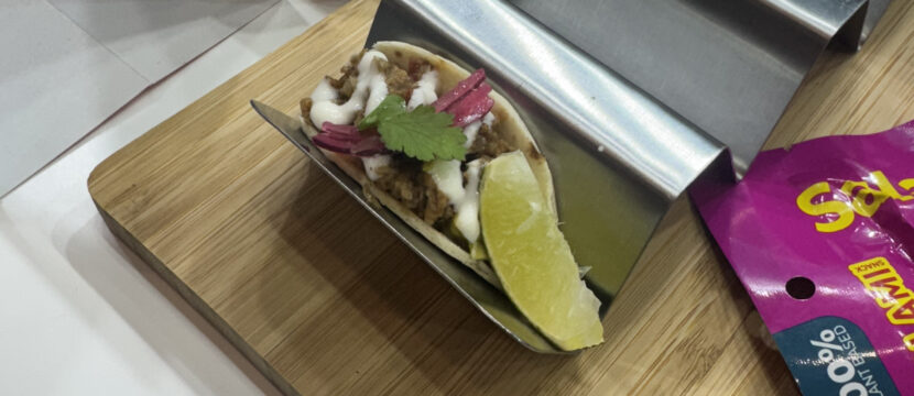 Plant-based pulled pork-style tacos on display for guests to try at AIX 2025