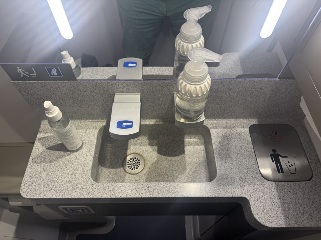 Inside the lav in the airBaltic A220, with a focus on the very clean sink area.