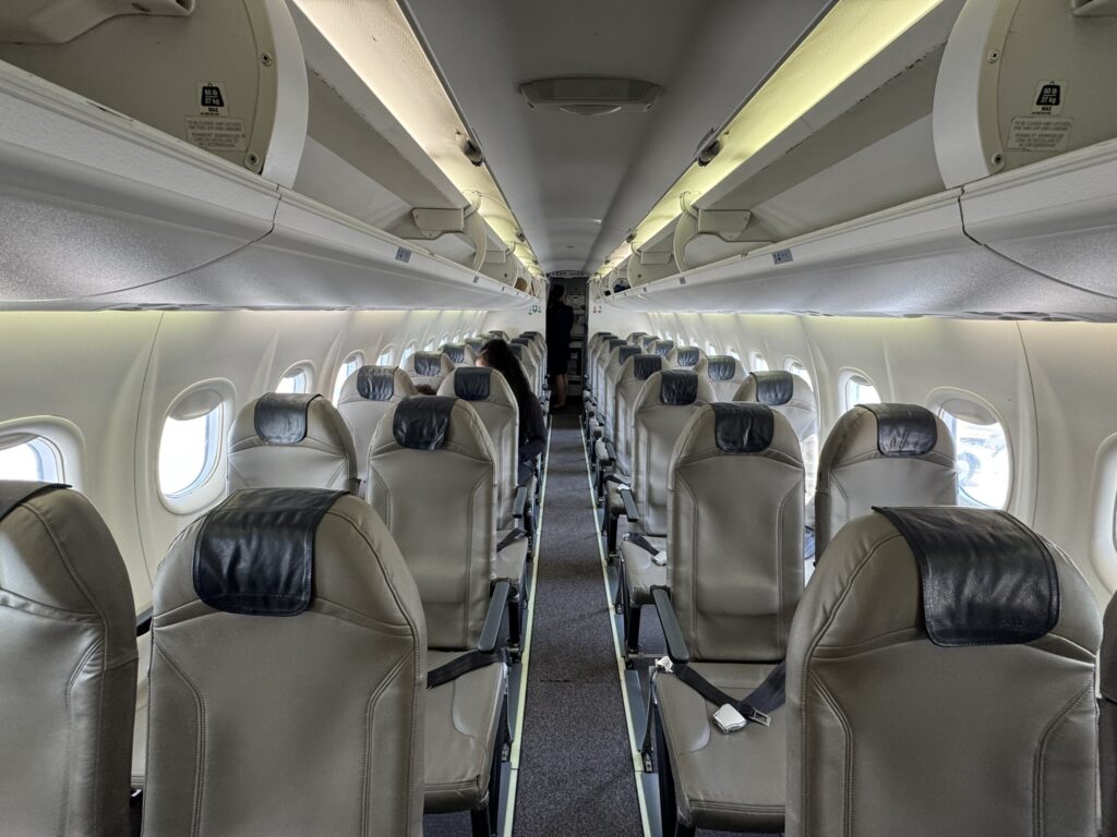 Cabin of Porter Q400, configured 2-2 with thinly-padded seats.