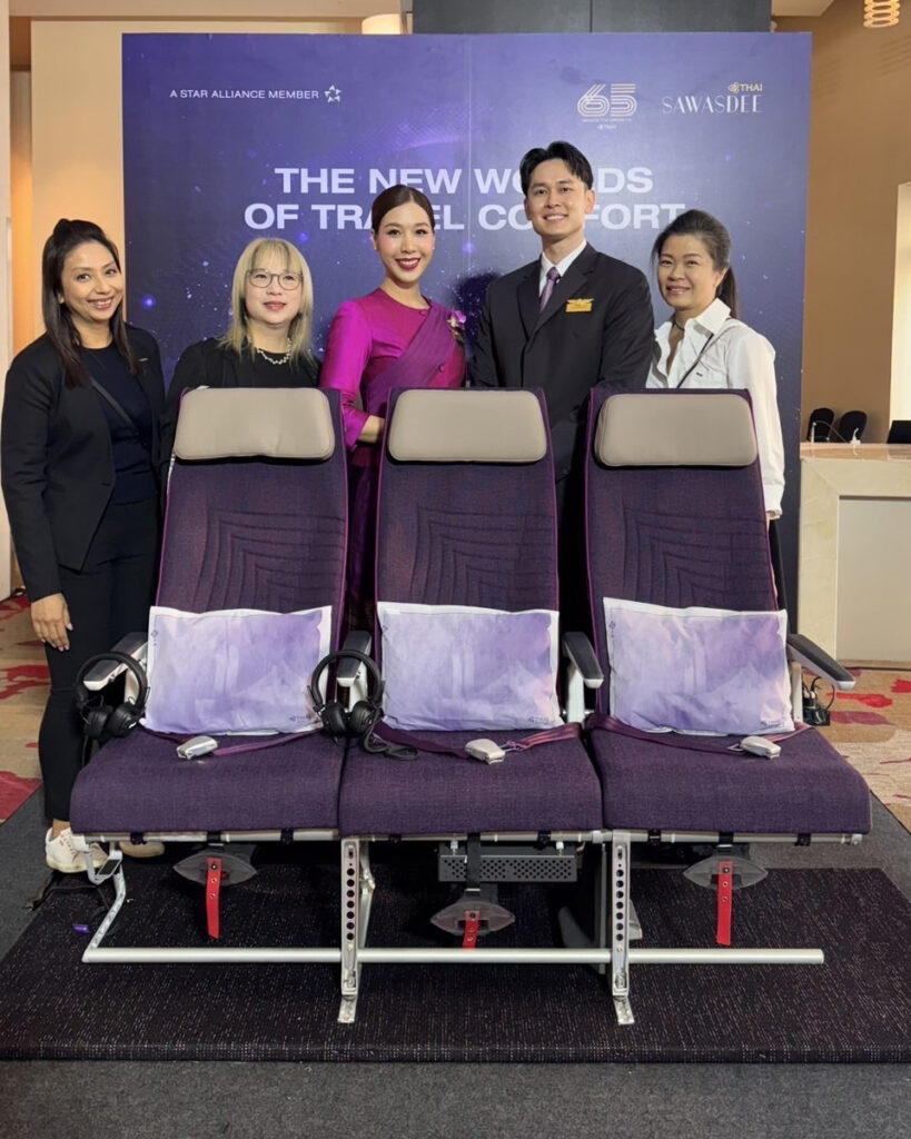Executives of Thai stand behind a RECARO R3 seat triple
