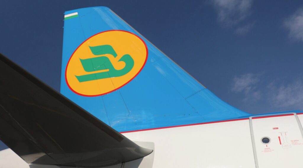 Uzbekistan Airways A321ceo tail with the carrier green, yellow, blue, red and white livery.