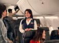 American Airlines crew member speaking with a passenger. The airline has formed a Customer Experience Advisory Board.