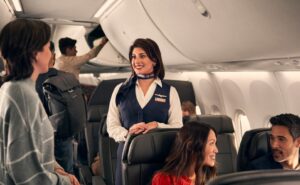 American Airlines crew member speaking with a passenger. The airline has formed a Customer Experience Advisory Board.