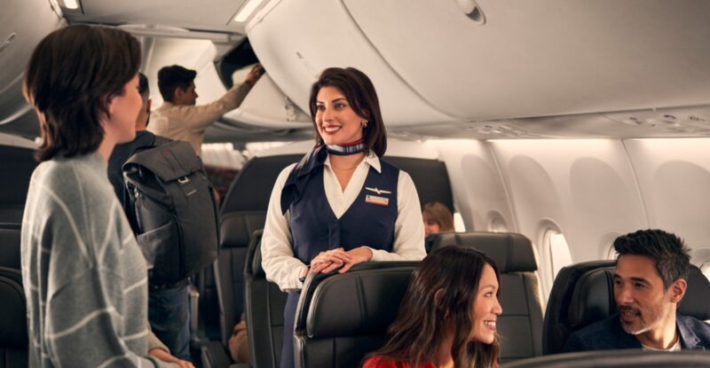 American Airlines crew member speaking with a passenger. The airline has formed a Customer Experience Advisory Board.