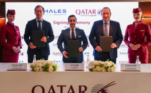 Thales and Qatar Airways executives stand for a photo together at the signing.