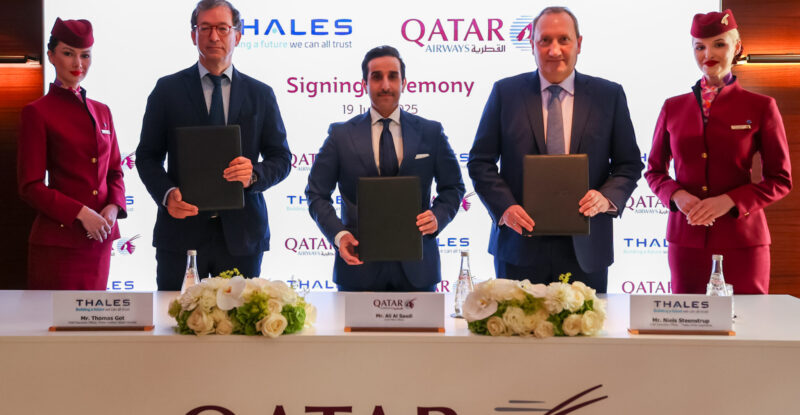 Thales and Qatar Airways executives stand for a photo together at the signing.