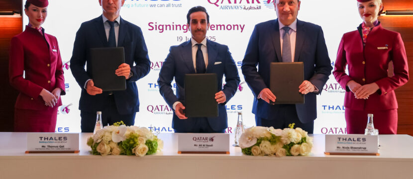 Thales and Qatar Airways executives stand for a photo together at the signing.
