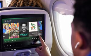 Spotify is shown on the Untied Airlines A321neo seatback IFE screen being used by a passenger.