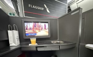 Inside seat 1D, a Flagship Preferred suite on the American Airlines 787-9P. An IFE screen is in view, as is the word Flagship on the monument in front.