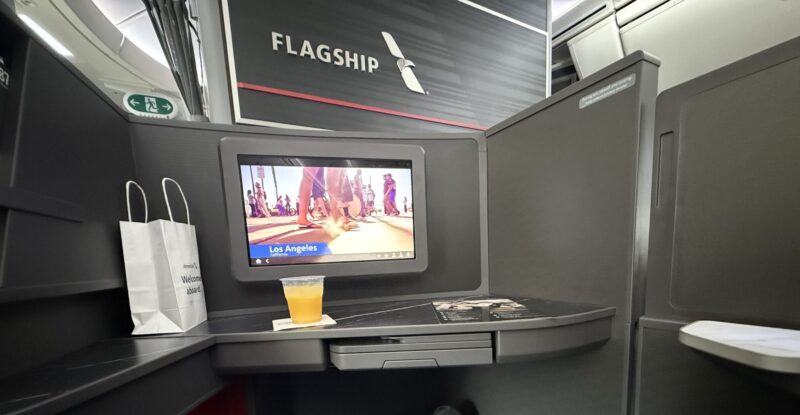 Inside seat 1D, a Flagship Preferred suite on the American Airlines 787-9P. An IFE screen is in view, as is the word Flagship on the monument in front.