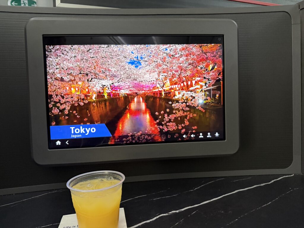 Bright IFE screen showing content about Tokyo in the Preferred suite