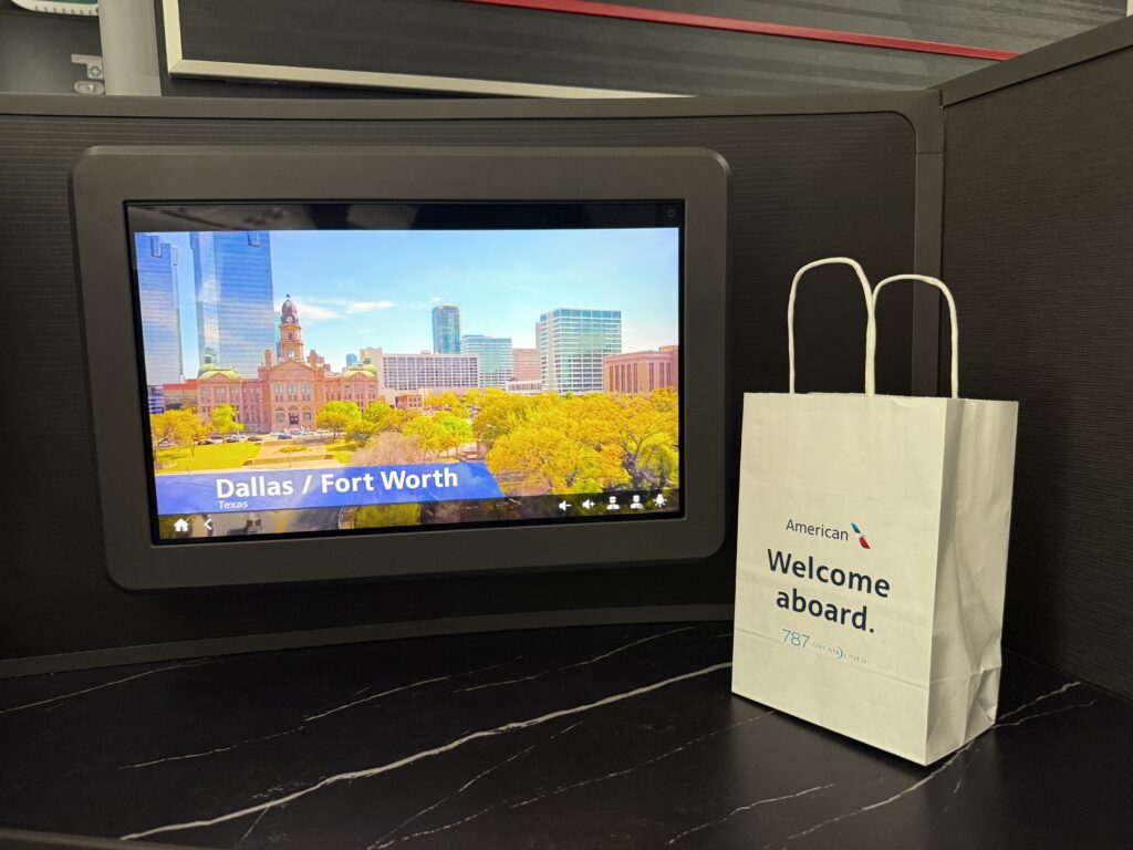 Thales AVANT Optiq system featuring a 17.5-inch 4K display. A 'Welcome Aboard' gift bag awaits the passenger.