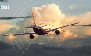 An aircraft is flying into the sunset with a Gilat logo in the top left corner