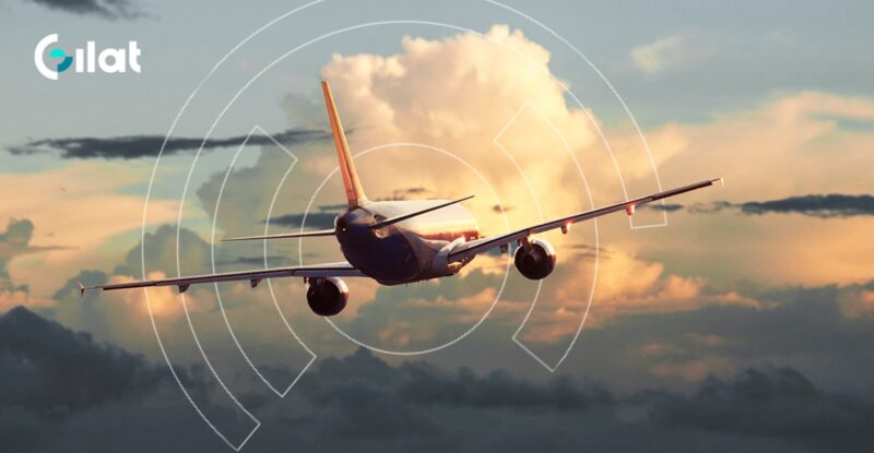 An aircraft is flying into the sunset with a Gilat logo in the top left corner