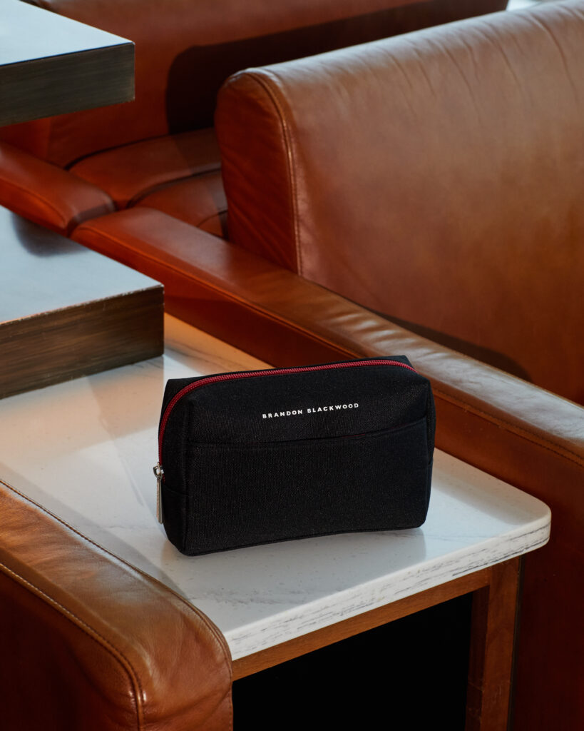 American Airlines amenity kit bag, designed by Brandon Blackwood, sits atop a side table