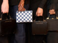 American Airlines amenity kit satchels, used as bags by four people. They are designed by Brandon Blackwood