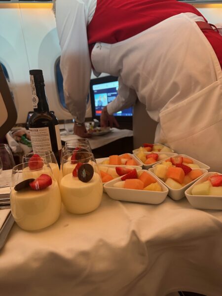 An Austrian flight attendant distributes dessert from the trolley