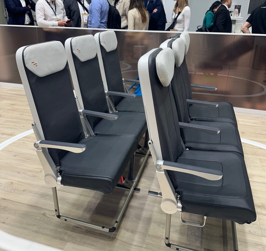 Two seat triples of Expliseat aircraft seats on the AIX show floor.