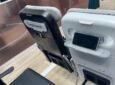 Close up of the Expliseat seat and PED holder on the AIX show floor. The word Expliseat is on the seatback of one of the seats.