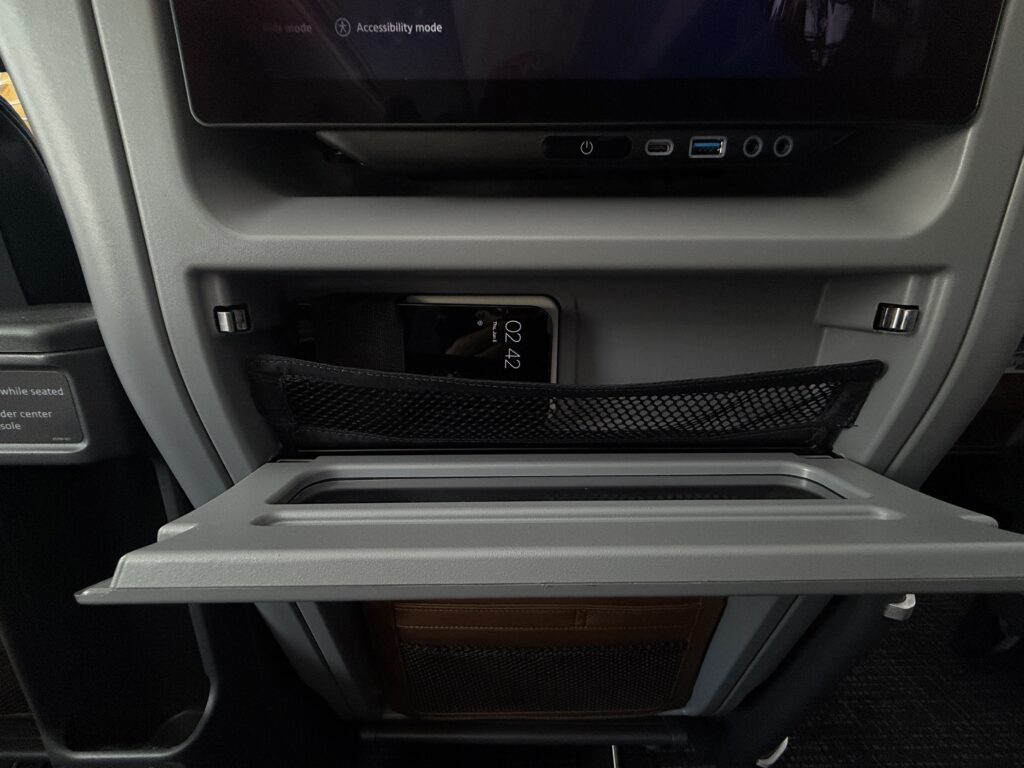 The author's device charges whilst positioned in a netted pocket int he seatback. 