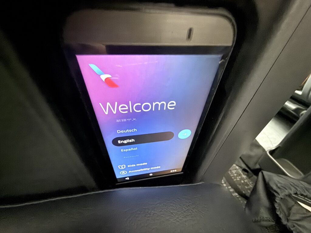 Close up of tethered remote tucked into its seat slot.