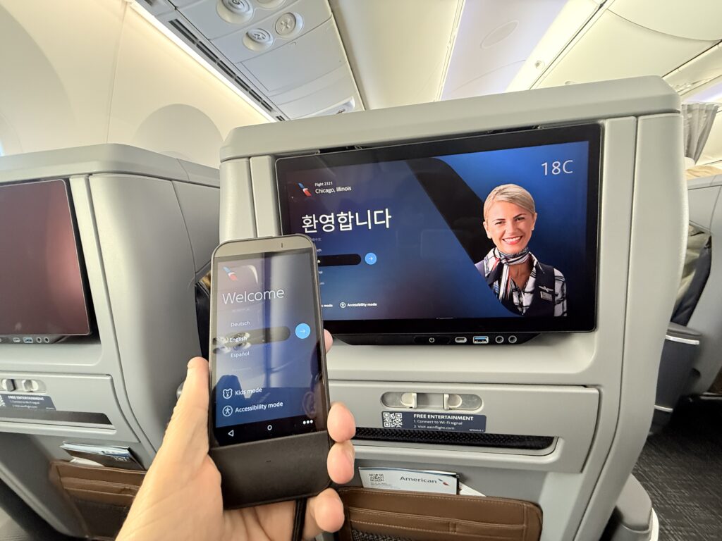 The author holds up the tethered remote, close to the IFE screen.