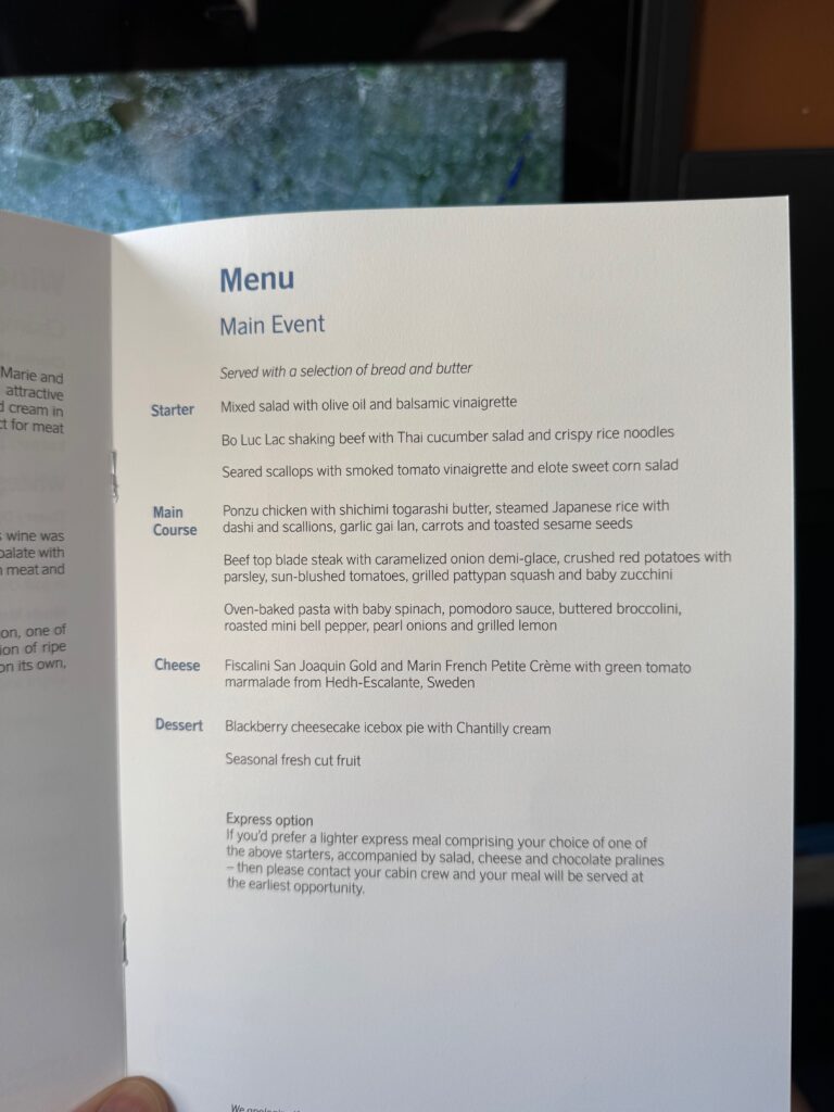 Menu in business class with multiple starters and main dishes on offer.