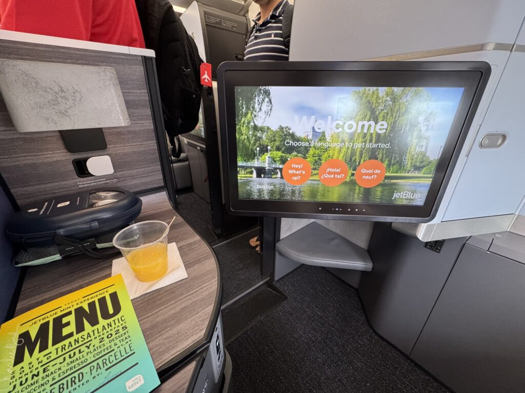 A close up of the IFE screen in JetBlue Mint Studio