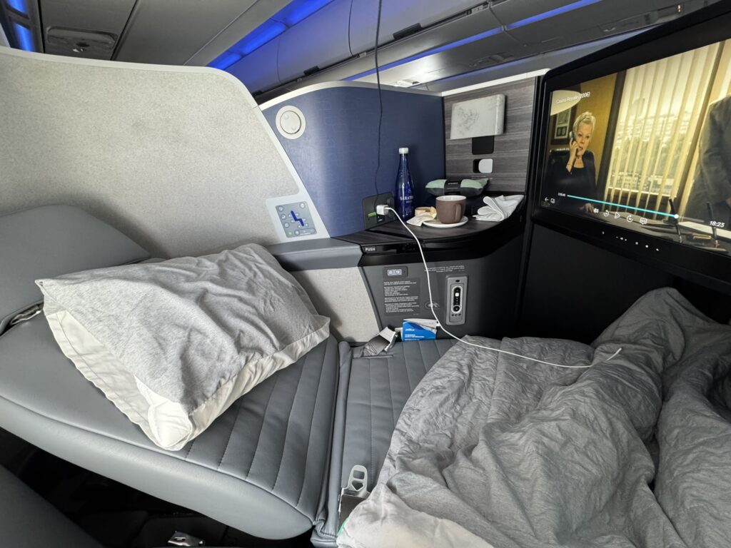 JetBlue Mint Studio in bed mode with bedding atop it