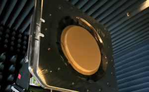 The multi-band, multi-beam, multi-orbit ESA from Kymeta is hanging in a protected chamber. It is a large red circle.