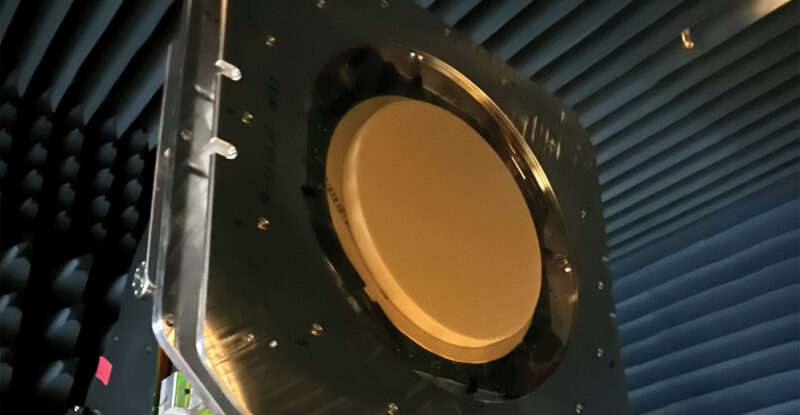 The multi-band, multi-beam, multi-orbit ESA from Kymeta is hanging in a protected chamber. It is a large red circle.