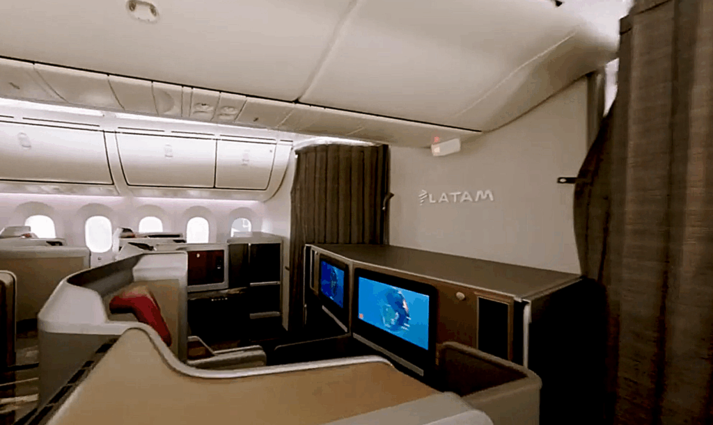 LATAM logo in silver on a monument at the front of the business class cabin.