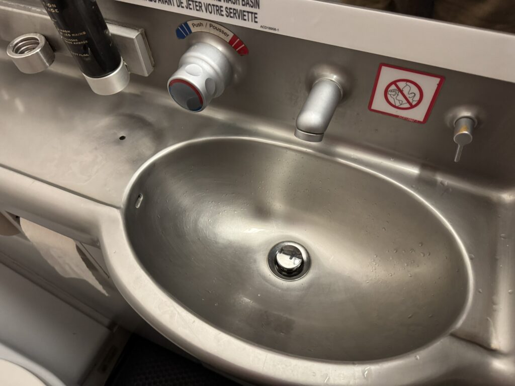 Metal sink in the aircraft lavatory