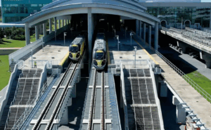 Two Brightline trains are exiting the station