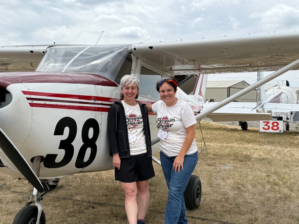 Team 38 - Penguin Power -Elizabeth Menozzi Sammy-Rai Brain at the end of the race, posing for a photo in front of their aircraft.