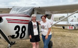 Team 38 - Penguin Power -Elizabeth Menozzi Sammy-Rai Brain at the end of the race, posing for a photo in front of their aircraft.