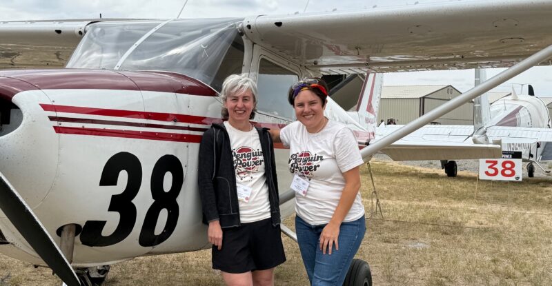 Team 38 - Penguin Power -Elizabeth Menozzi Sammy-Rai Brain at the end of the race, posing for a photo in front of their aircraft.