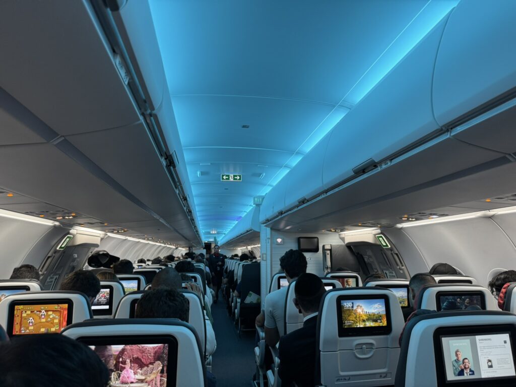 Full cabin view of the fresh new interior on this Air Canada A321. Blue LED lighting creates a clam atmosphere on board.